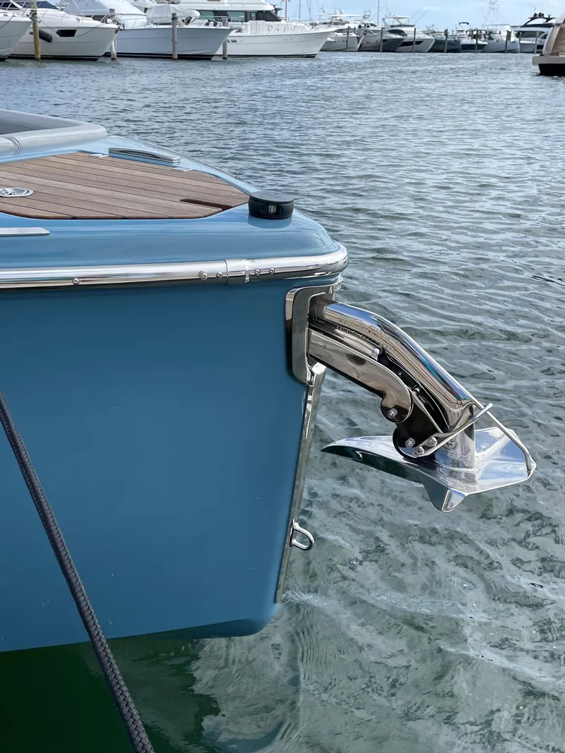 Slide: The Image of 2022 Cranchi 26 Rider boat anchored in marina, showcasing sleek design and modern features. - 7