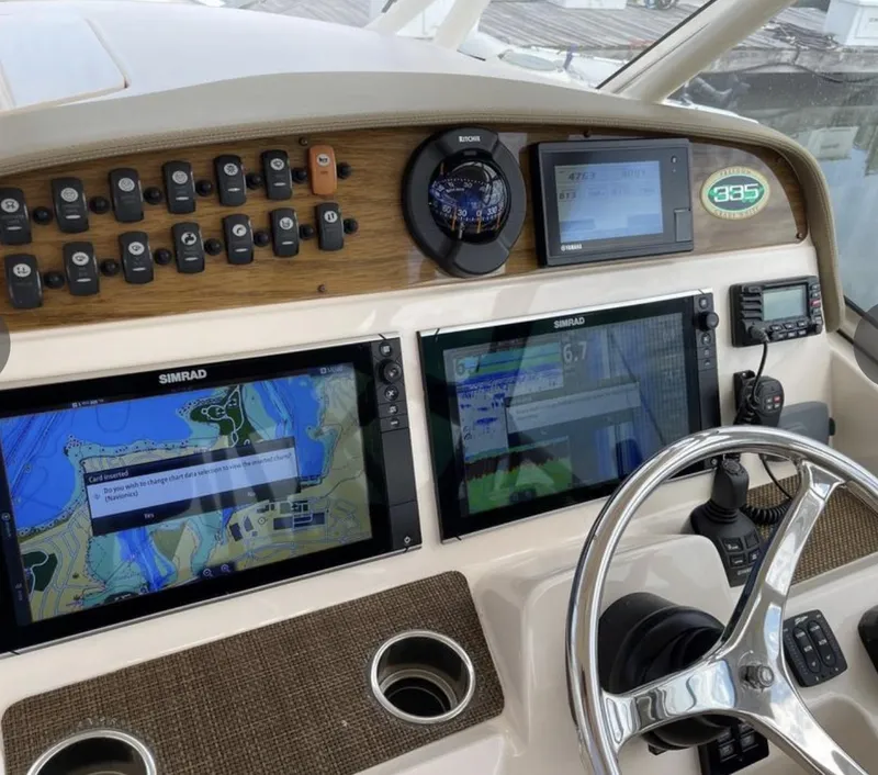 Slide: The Image of Control panel of 2014 Grady-White Freedom 335 boat with navigation screens and steering wheel. - 3