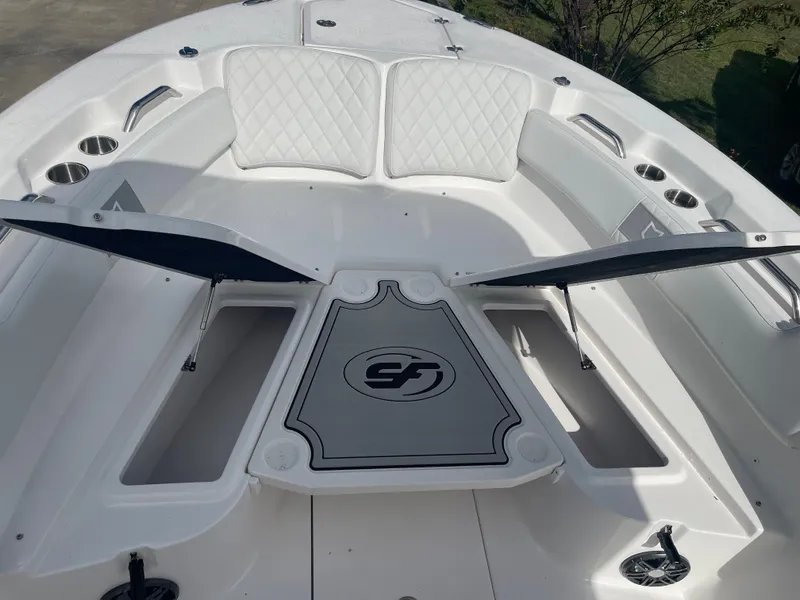 Slide: The Image of 2024 Sea Fox 248 Commander boat with open storage compartments and cushioned seating. - 11