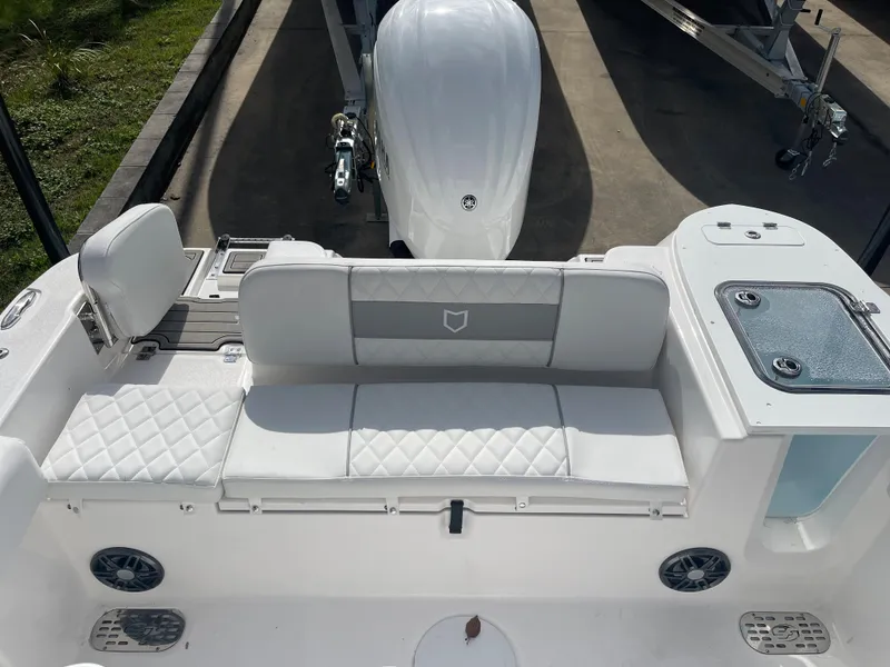 Slide: The Image of 2024 Sea Fox 248 Commander boat interior with white cushioned seating and storage compartments. - 13