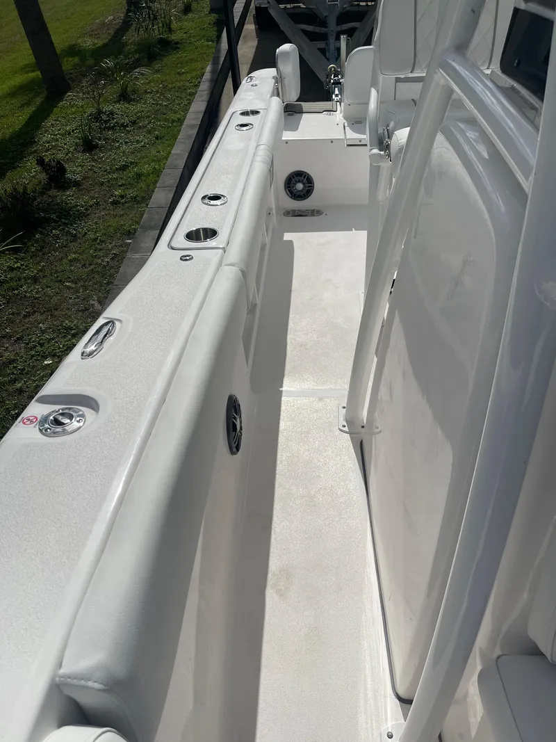 Slide: The Image of 2024 Sea Fox 248 Commander boat interior, featuring sleek white deck and seating. - 16