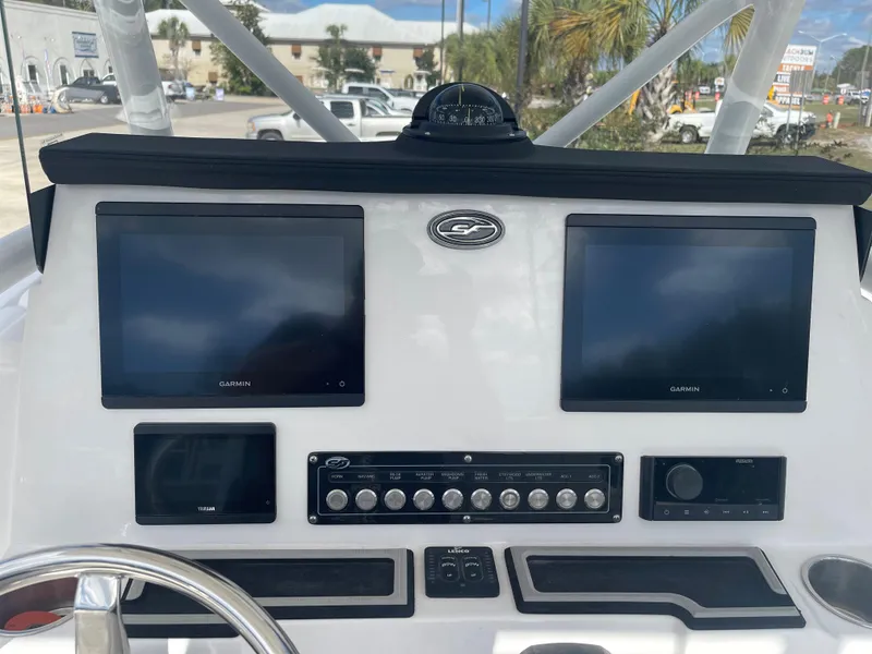 Slide: The Image of 2024 Sea Fox 248 Commander boat dashboard with dual Garmin screens and control panel. - 4