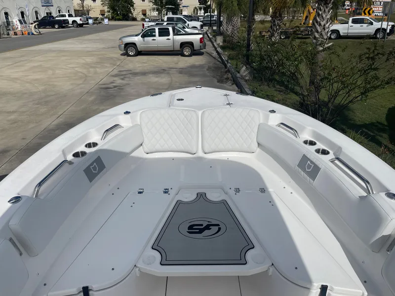 Slide: The Image of 2024 Sea Fox 248 Commander boat bow seating area with white cushions and cup holders. - 7