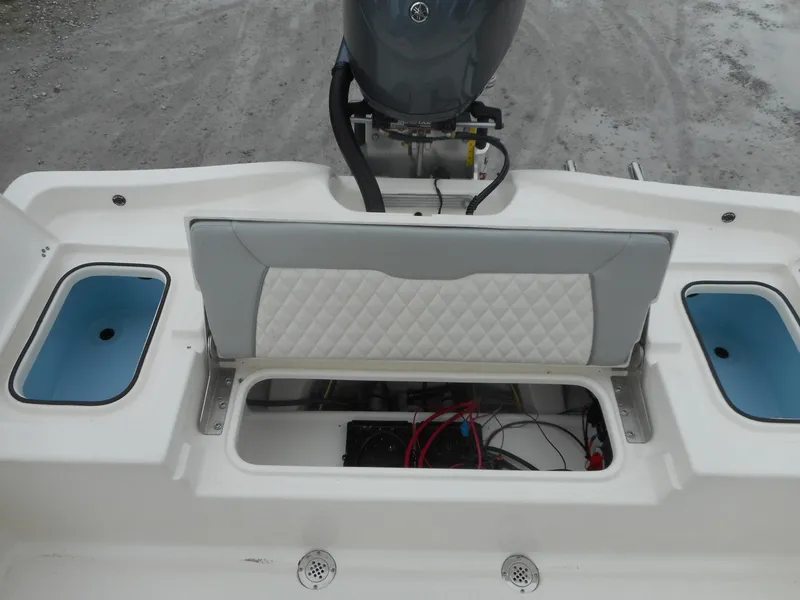 Slide: The Image of 2024 Avenger 24 Avenger boat rear seating and storage compartment. - 10
