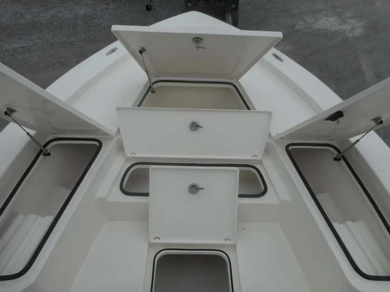 Slide: The Image of 2024 Avenger 24 Avenger boat with open storage compartments. - 12