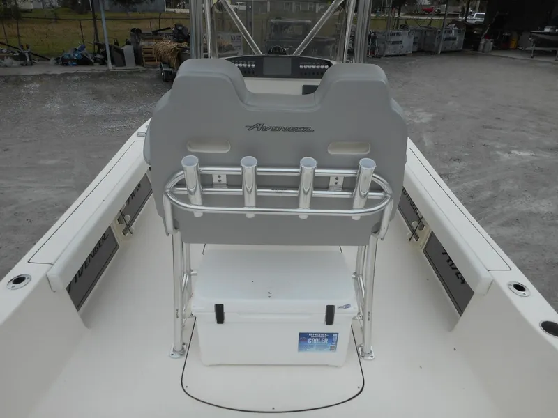 Slide: The Image of 2024 Avenger 24 Avenger boat interior with rod holders and cooler. - 6