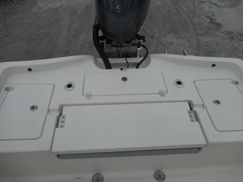 Slide: The Image of 2024 Avenger 24 Avenger boat stern with storage compartments and outboard motor. - 8