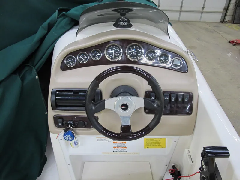 Slide: The Image of 1998 Chaparral 252 Sunesta boat dashboard with steering wheel and instrument panel. - 7