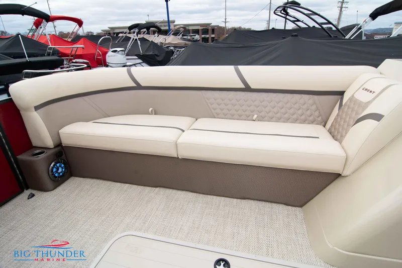 Slide: The Image of 2023 Crest Classic Platinum 240 SLC boat interior with beige seating. - 12