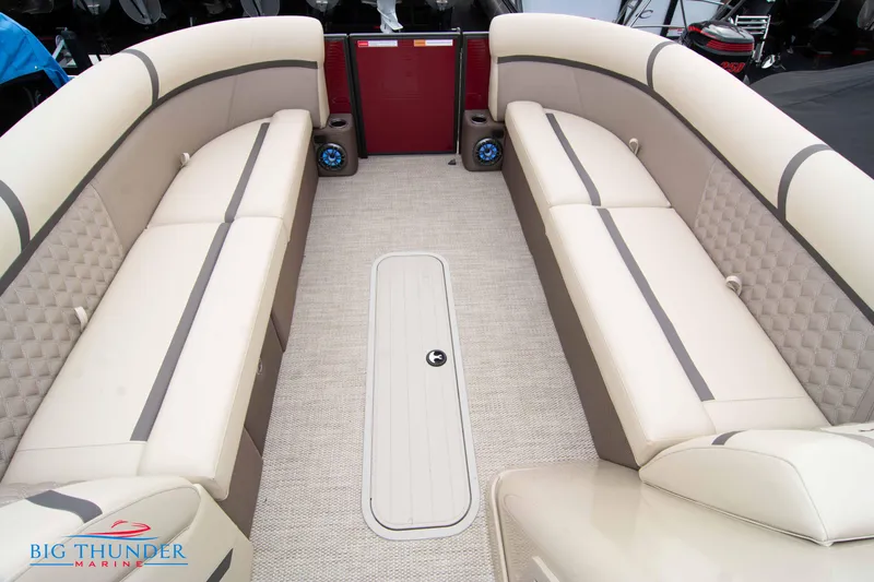 Slide: The Image of 2023 Crest Classic Platinum 240 SLC boat interior with beige seating and carpet flooring. - 13