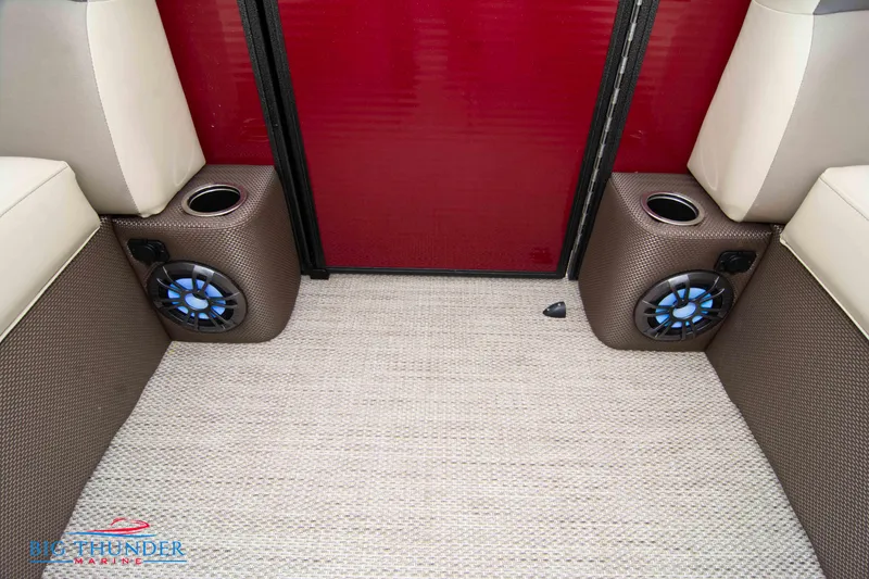 Slide: The Image of 2023 Crest Classic Platinum 240 SLC boat interior with speakers and cup holders. - 14