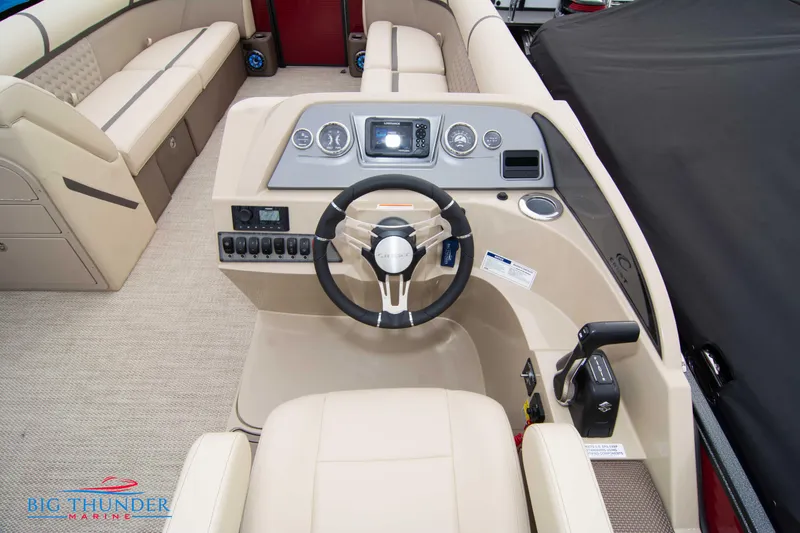 Slide: The Image of 2023 Crest Classic Platinum 240 SLC boat interior with steering console and seating. - 26