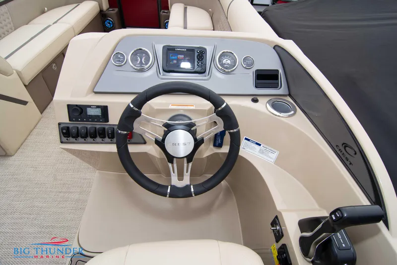 Slide: The Image of 2023 Crest Classic Platinum 240 SLC boat dashboard with steering wheel and control panel. - 27