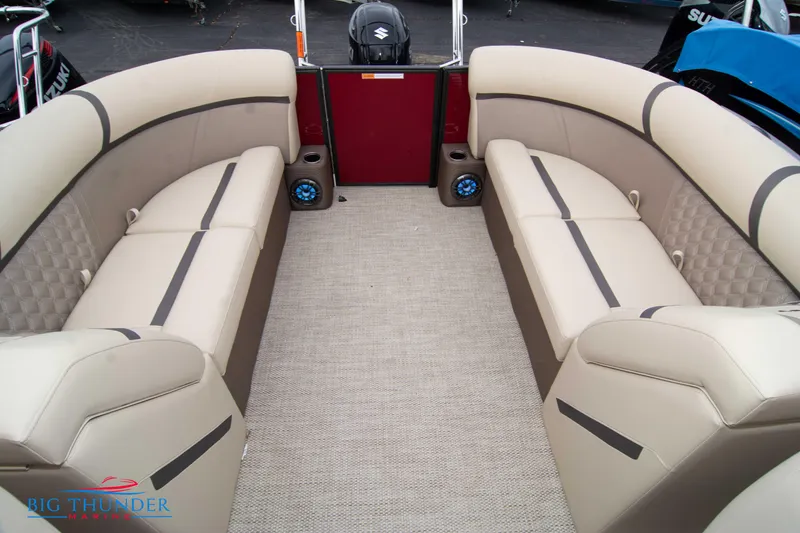 Slide: The Image of 2023 Crest Classic Platinum 240 SLC boat interior with beige seating and carpet flooring. - 38