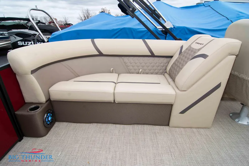 Slide: The Image of 2023 Crest Classic Platinum 240 SLC boat interior with beige seating. - 39