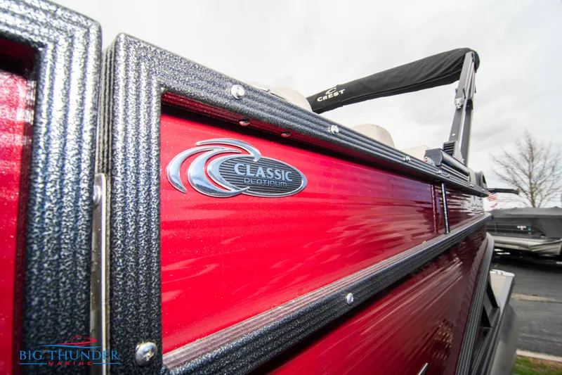 Slide: The Image of 2023 Crest Classic Platinum 240 SLC pontoon boat with red exterior. - 7