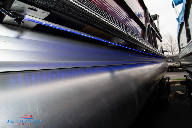 Slide: The Image of 2023 Crest Classic Platinum 240 SLC pontoon boat with blue LED lighting. - 8