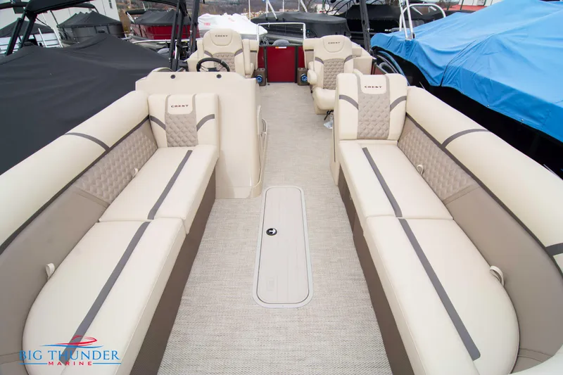 Slide: The Image of 2023 Crest Classic Platinum 240 SLC pontoon boat interior with beige seating. - 9