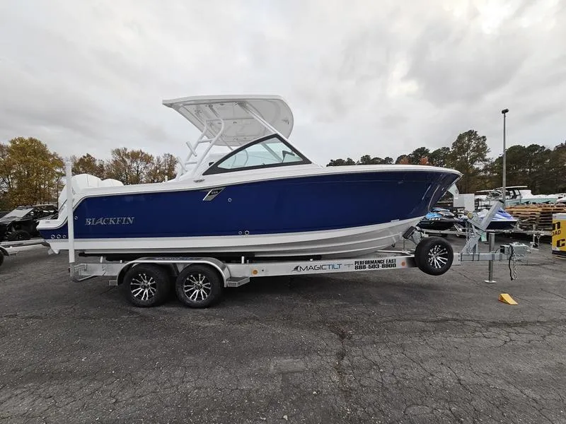 Slide: The Image of 2024 Blackfin 252 DC boat on a trailer in a parking lot. - 1