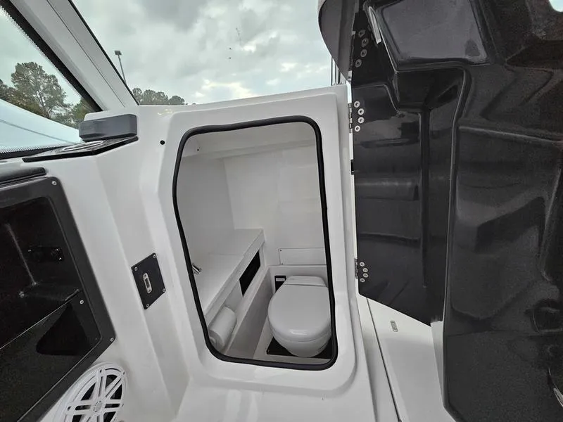 Slide: The Image of 2024 Blackfin 252 DC boat interior with a compact marine toilet. - 10