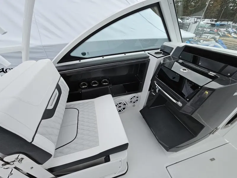 Slide: The Image of 2024 Blackfin 252 DC boat interior with seating and control console. - 11