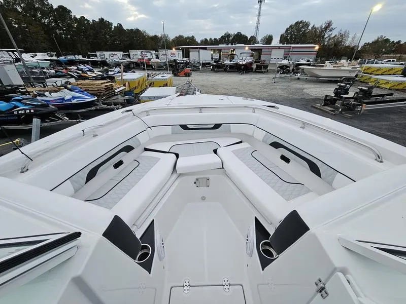 Slide: The Image of 2024 Blackfin 252 DC boat with spacious seating at a dealership. - 12