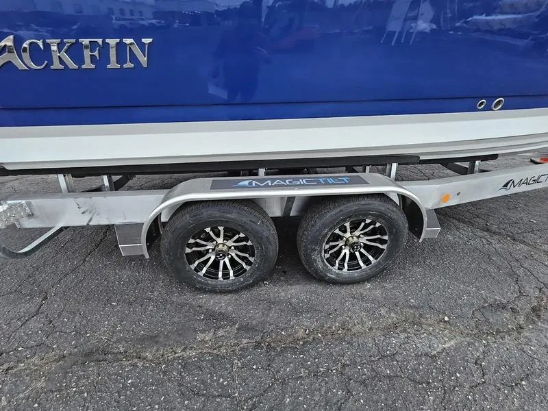 Slide: The Image of 2024 Blackfin 252 DC boat on a Magic Tilt trailer with dual axles. - 16