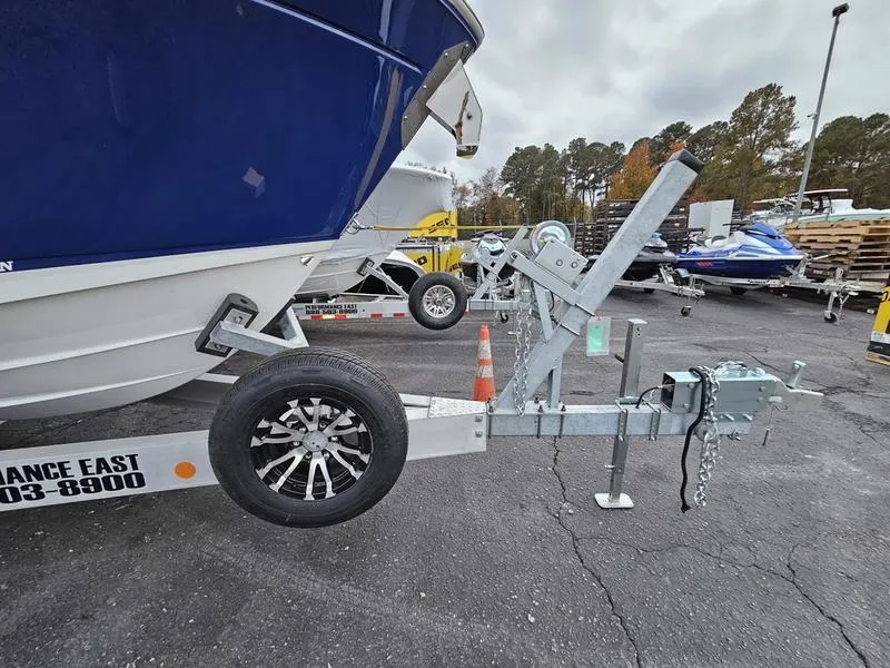 Slide: The Image of 2024 Blackfin 252 DC boat on a trailer in a parking lot. - 17