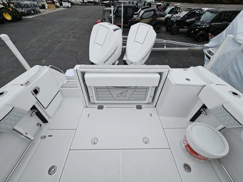Slide: The Image of 2024 Blackfin 252 DC boat deck with twin Mercury outboard engines. - 6