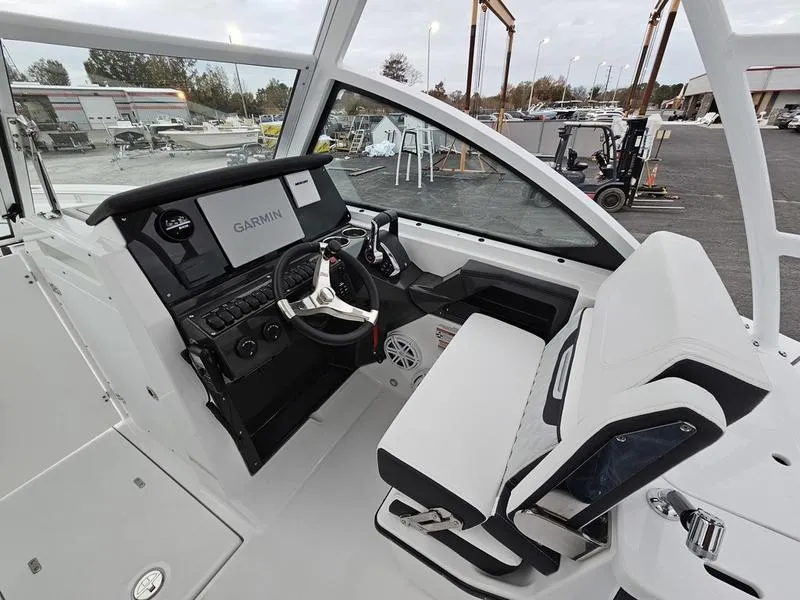 Slide: The Image of 2024 Blackfin 252 DC boat cockpit with Garmin navigation system and white seating. - 7