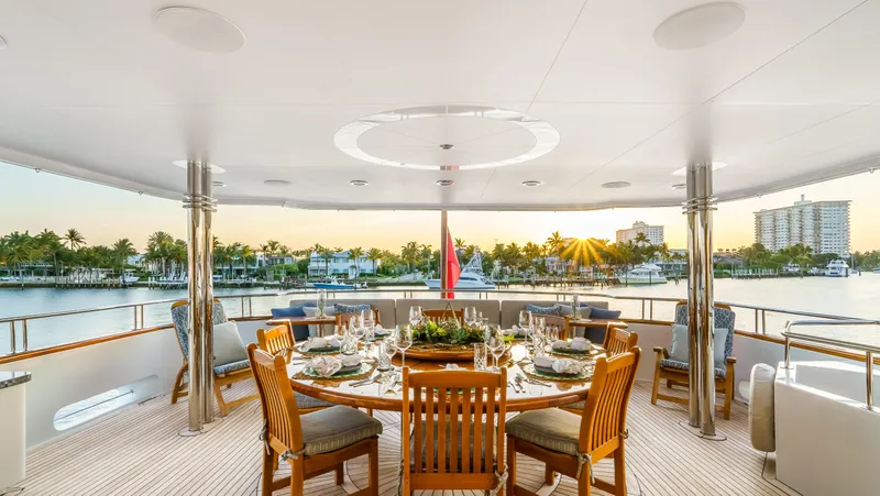 Slide: The Image of Luxurious dining area on 2004 Richmond Yachts Semi-Displacement, overlooking serene waterfront at sunset. - 24