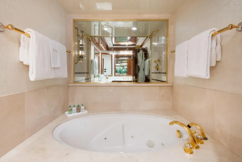 Slide: The Image of Luxurious yacht bathroom with jacuzzi tub, gold fixtures, and plush towels. Richmond Yachts 2004. - 14