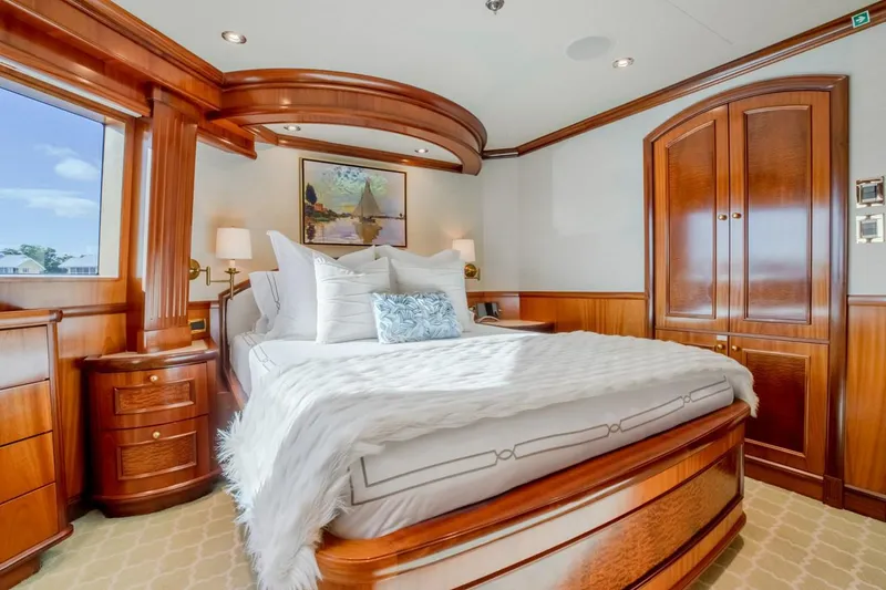 Slide: The Image of Luxurious bedroom interior on 2004 Richmond Yachts Semi-Displacement, featuring elegant wood finishes. - 29