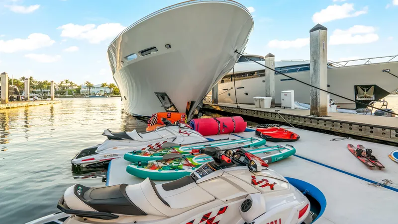 Slide: The Image of Luxury Richmond Yachts 2004 docked with jet skis and paddleboards nearby. - 35