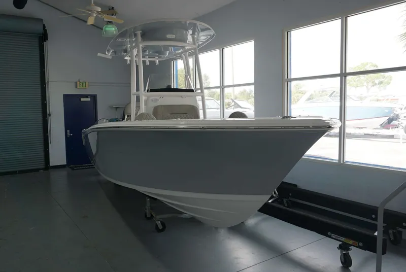 Slide: The Image of 2024 Sportsman 212 Open boat displayed indoors. - 1