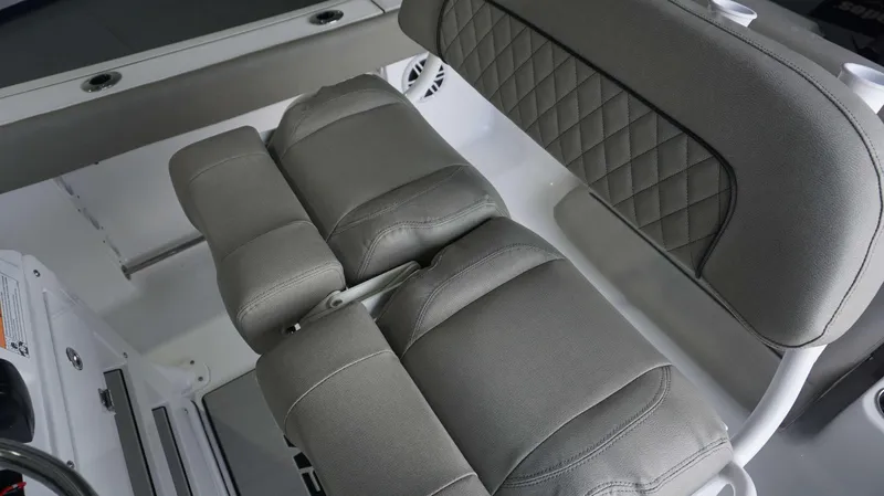 Slide: The Image of 2024 Sportsman 212 Open boat with gray cushioned seating and diamond-stitched backrest. - 8