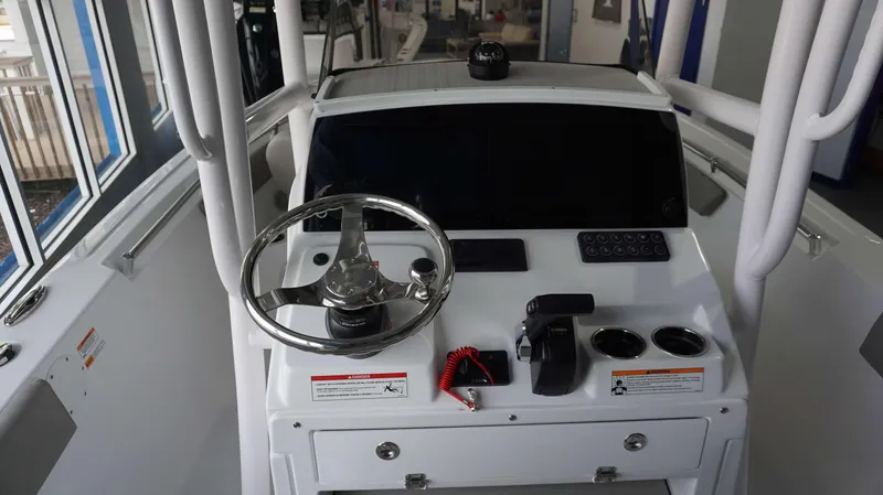 Slide: The Image of 2024 Sportsman 212 Open boat console with steering wheel and controls. - 9