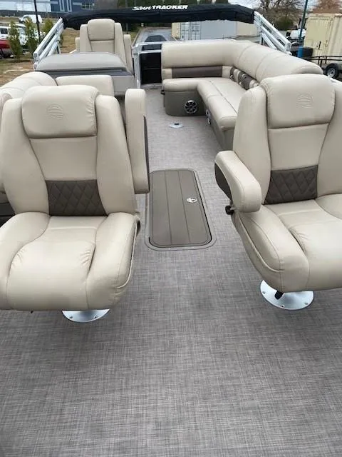 Slide: The Image of 2024 Sun Tracker Sportfish 24 XP3 interior with beige seating and spacious layout. - 2