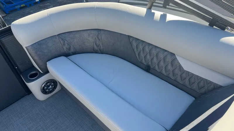 Slide: The Image of 2020 Crest Classic Platinum 220 SLC boat interior with cushioned seating and speaker. - 10