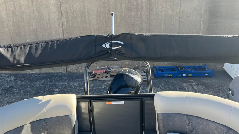 Slide: The Image of 2020 Crest Classic Platinum 220 SLC boat with covered canopy and outboard motor. - 11
