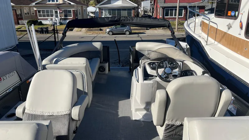 Slide: The Image of 2020 Crest Classic Platinum 220 SLC boat interior with steering console and seating. - 12