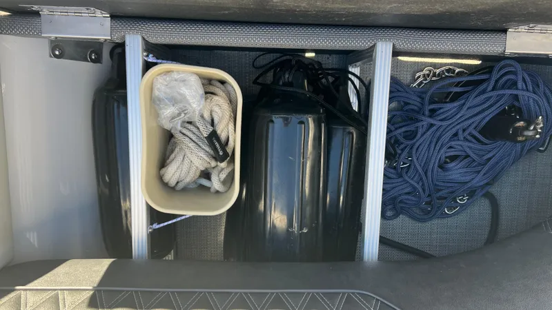 Slide: The Image of Storage compartment of 2020 Crest Classic Platinum 220 SLC with ropes and fenders. - 13