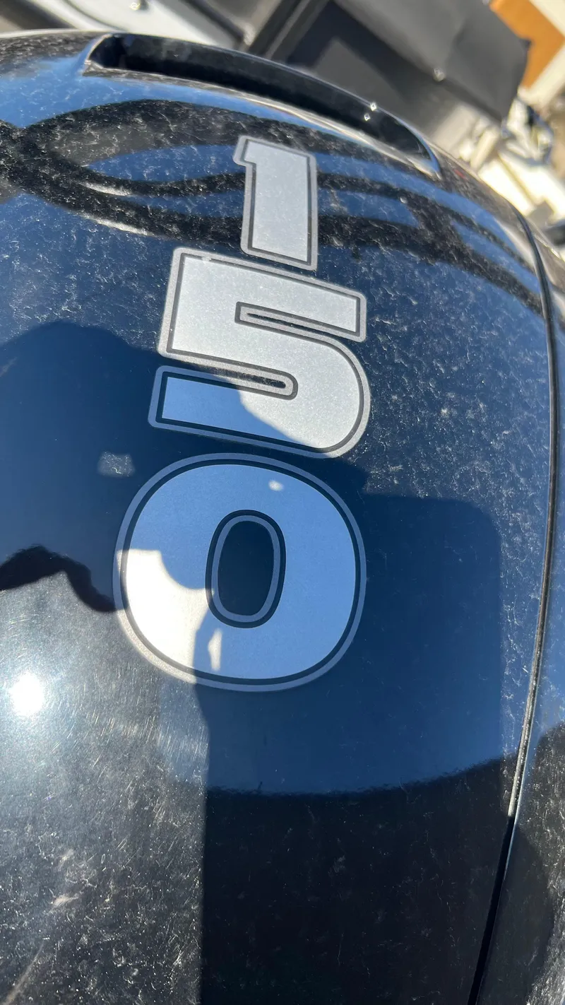 Slide: The Image of Close-up of the 150 HP engine on a 2020 Crest Classic Platinum 220 SLC boat. - 16