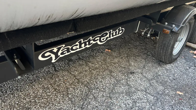 Slide: The Image of Close-up of a 2020 Crest Classic Platinum 220 SLC boat trailer with Yacht Club branding. - 23