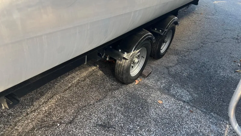 Slide: The Image of Trailer wheels of a 2020 Crest Classic Platinum 220 SLC on a paved surface. - 25