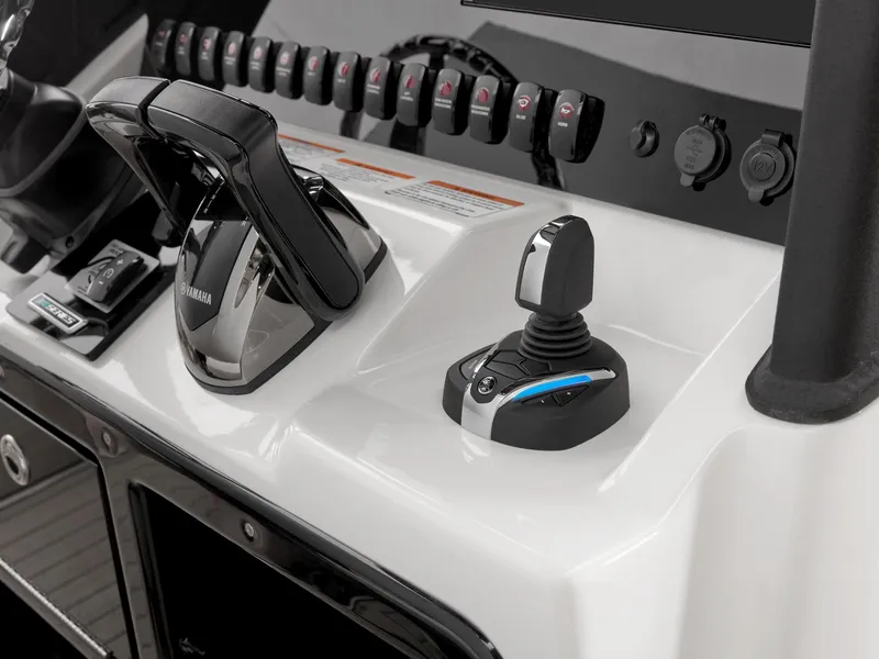 Slide: The Image of 2024 Yamaha Boats 255 FSH Sport H control panel with joystick and throttle. - 5