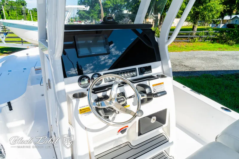 Slide: The Image of 2024 Sea Fox 231 Bay Fox Center Console boat interior with steering wheel and controls. - 14