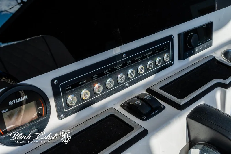 Slide: The Image of 2024 Sea Fox 231 Bay Fox Center Console dashboard with Yamaha controls and Black Label Marine branding. - 17