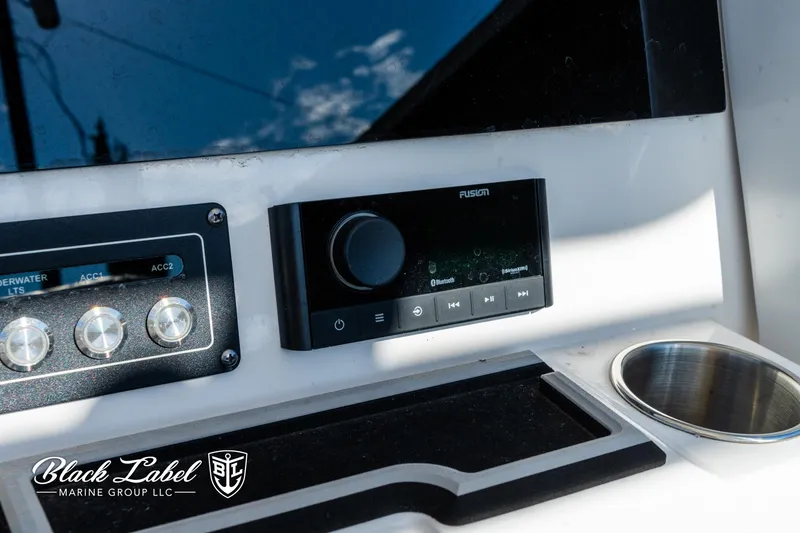 Slide: The Image of 2024 Sea Fox 231 Bay Fox Center Console dashboard with controls and cup holder. - 19