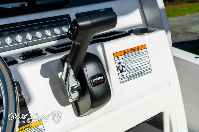 Slide: The Image of 2024 Sea Fox 231 Bay Fox Center Console throttle control with Yamaha branding and warning labels. - 20
